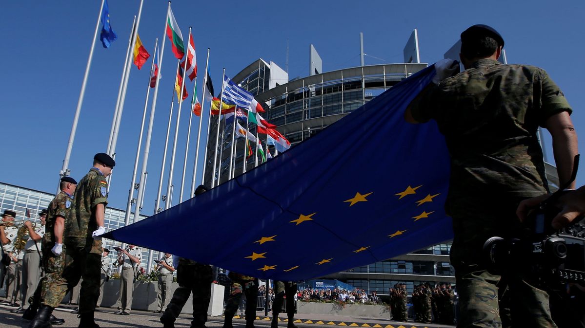 Eurocorps soldiers hold the European flag in front of the EU Parliament in Strasbourg, France.