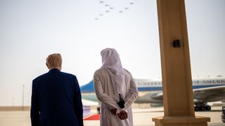 Der US-Präsident und der Emir von Katar stehen mit dem Rücken zur Kamera und schauen auf ein Flugzeug