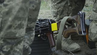 Close-up view of a soldier's shoes and trousers