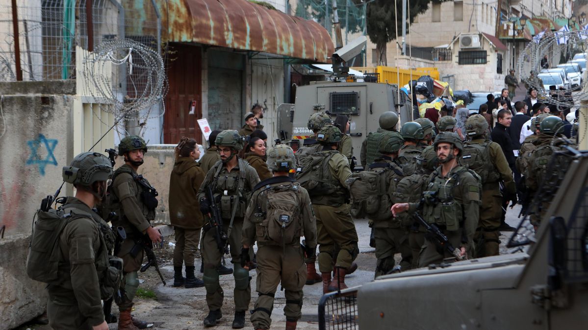 Israeli security forces guard Israeli settlers on their tour of the West Bank city of Hebron.
