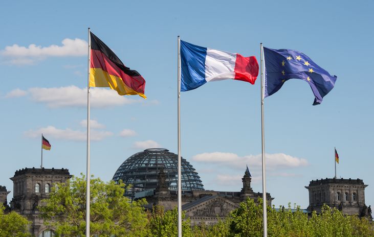 The flags of Germany, France and the European Union with the view of the Reichstag The flags of Germany, France and the European Union with the view of the Reichstag
