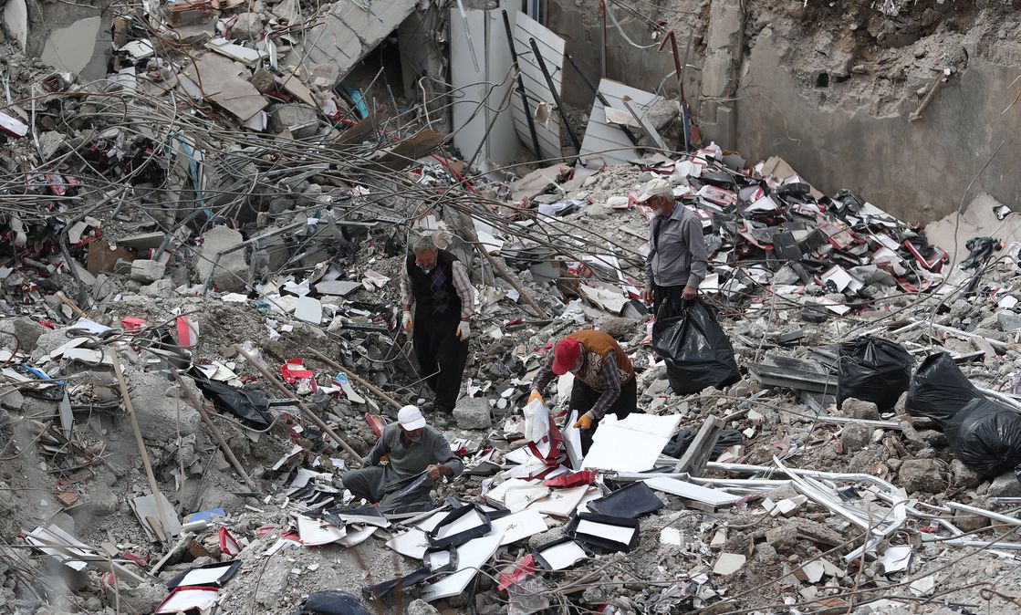Workers collect useful remains of their stuff from collapsed shops in Kahramanmaras, Turkey.