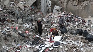 Workers collect useful remains of their stuff from collapsed shops in Kahramanmaras, Turkey.