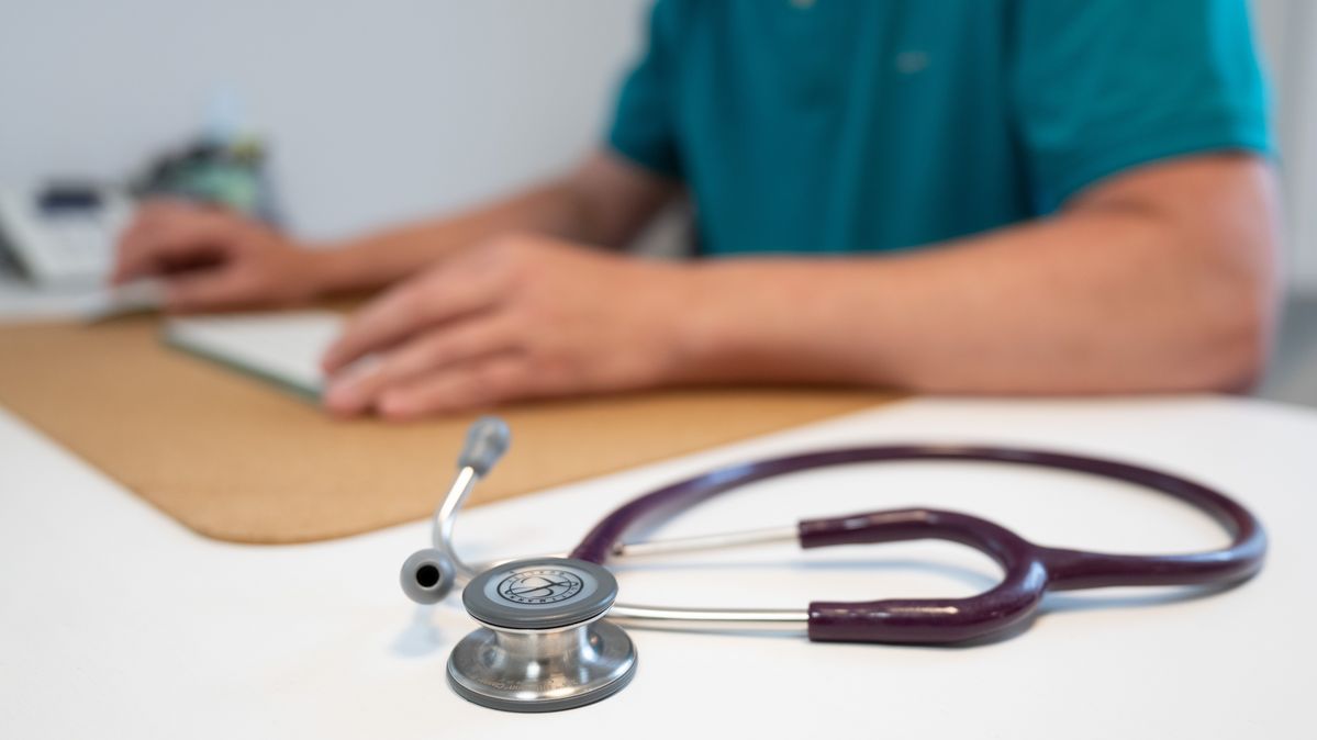 A stethoscope on a doctor’s desk next to a computer (illustrative image) A stethoscope on a desk