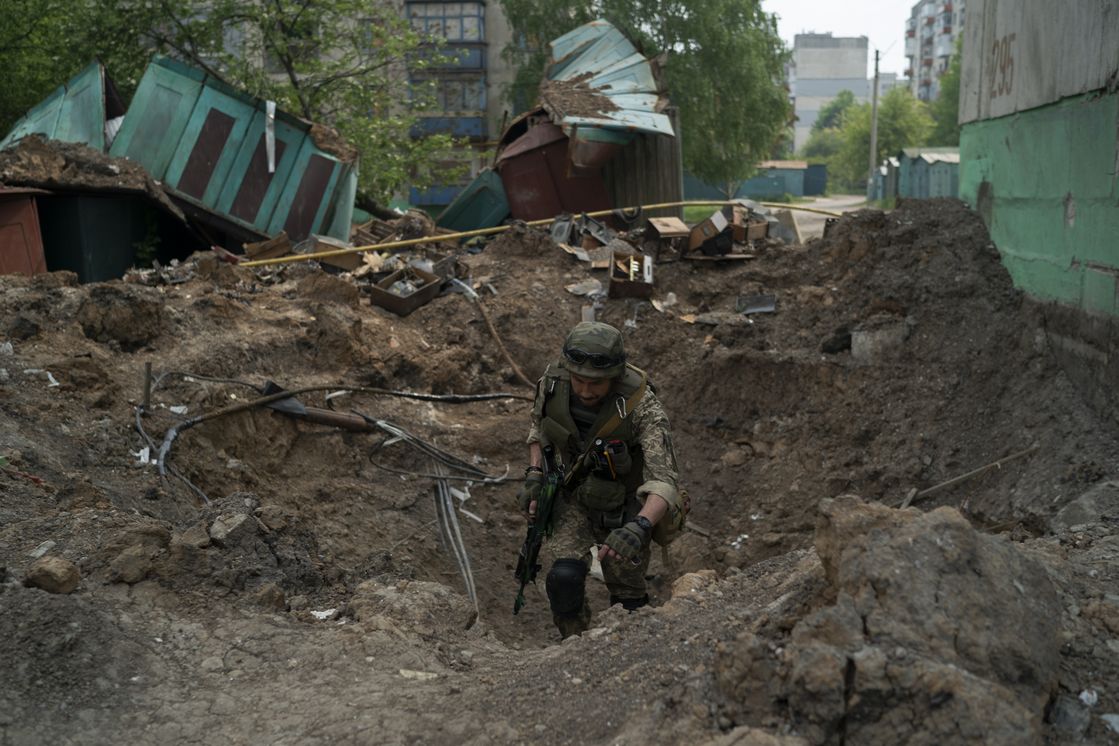 A police officer from a special unit inspects a site after an airstrike by Russian forces in Lysychansk, Luhansk region, Ukraine.