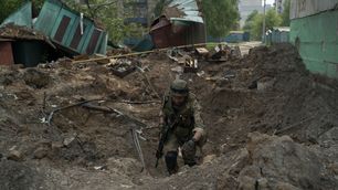 A police officer from a special unit inspects a site after an airstrike by Russian forces in Lysychansk, Luhansk region, Ukraine.