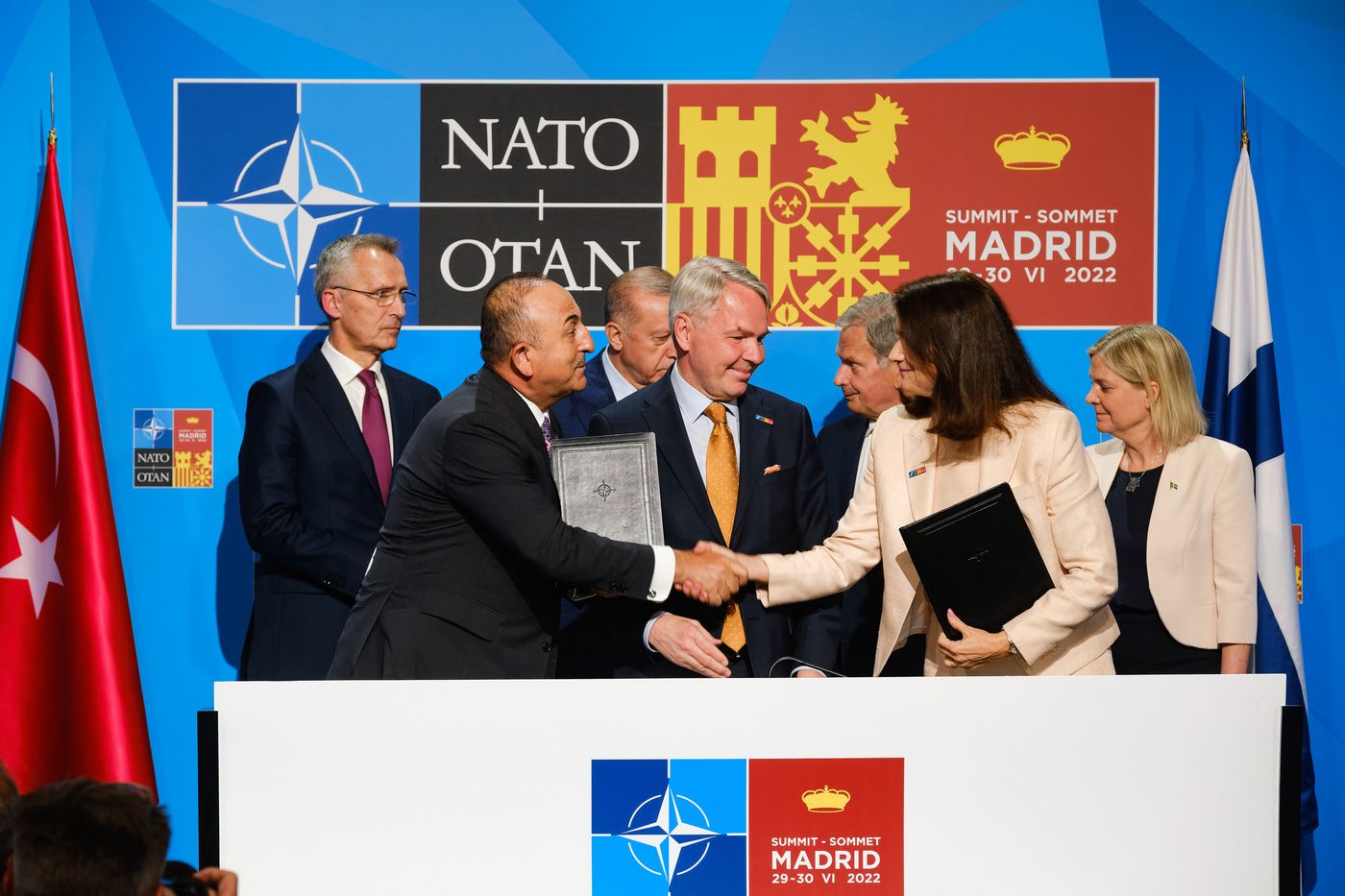 Mevlüt Çavuşoğlu, Minister of Foreign Affairs of Turkey, shakes hands with Ann Linde, Minister of Foreign Affairs of Sweden, during a signing ceremony paving the way for Finnish and Swedish NATO membership. 